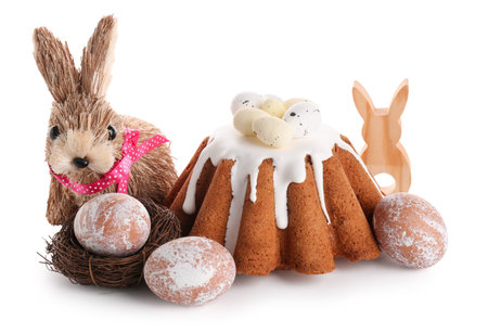 Sweet Easter bread with eggs and toy rabbit on white background