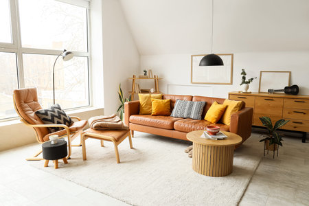Interior of living room with brown leather sofa, armchair, commode and coffee tableの写真素材