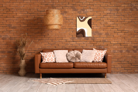 Cozy sofa with cushions in interior of living roomの写真素材