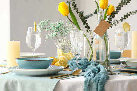 Elegant table setting with beautiful flowers and golden cutlery in restaurant
