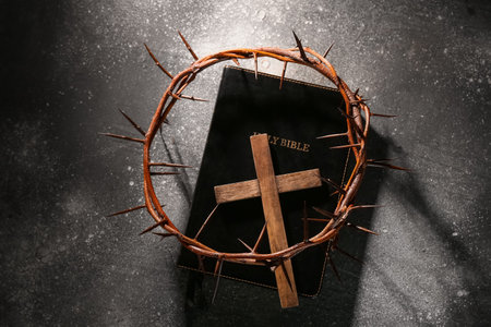 Crown of thorns with cross on gray grunge background