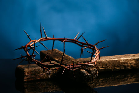 Crown of thorns with cross against dark blue background