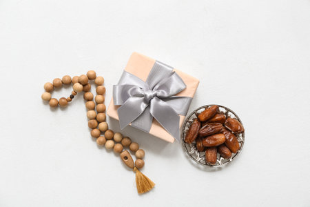Tasbih, dates and gift box on white grunge background. Ramadan celebrationの写真素材
