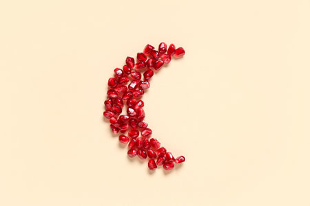 Crescent made of pomegranate seeds on color background. Ramadan celebrationの写真素材