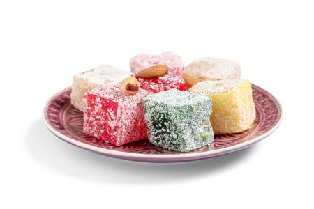 Plate with sweet Turkish delight on white background.