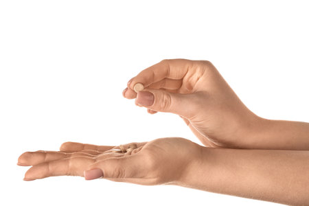 Female hands holding pills with iodine on white background. Closeupの写真素材
