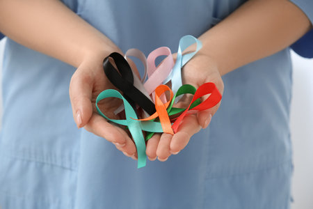 Female doctor with different awareness ribbons in clinic, closeup. World Health Dayの写真素材
