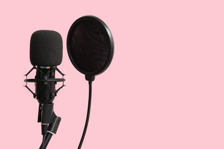 Stand with professional microphone on pink backgroundの写真素材