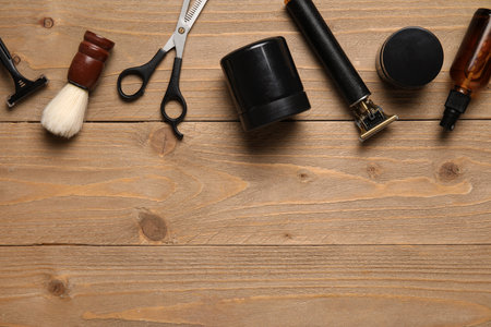 Modern trimmer and shaving accessories on wooden backgroundの写真素材