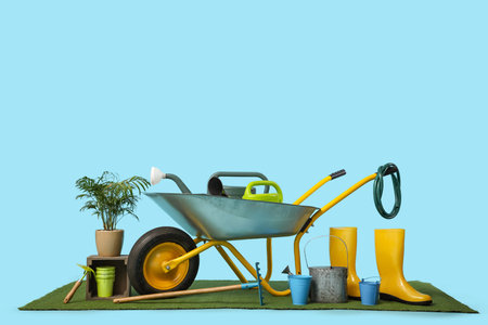 Gardening supplies with wheelbarrow on blue backgroundの写真素材