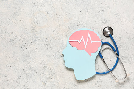 Paper human head with brain, cardiogram and stethoscope on light grunge background. Cancer conceptの写真素材