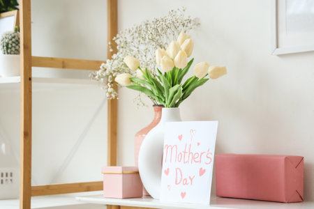 Card for Mother's Day with gifts and flowers on table in room, closeupの写真素材