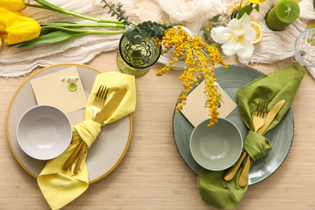 Beautiful table setting with spring flowers, top view