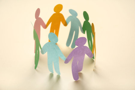 Paper human figures on light background. Inclusion conceptの写真素材
