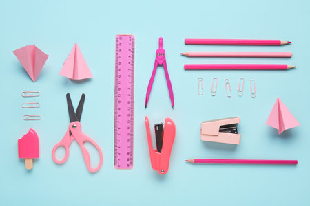 Set of pink school stationery with paper planes on blue backgroundの写真素材
