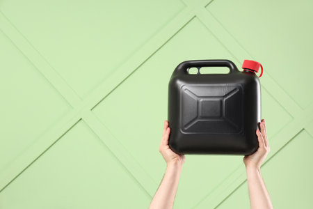 Male hands holding canister on green backgroundの写真素材