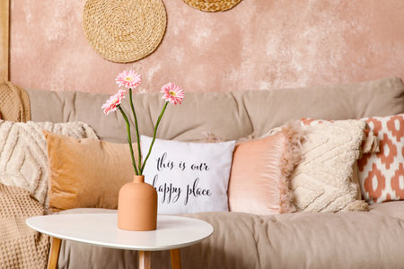Interior of stylish living room with white sofa and flowers on coffee tableの写真素材