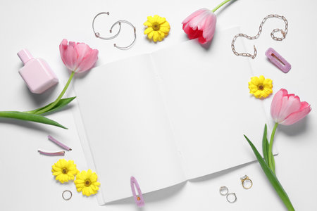 Blank fashion magazine with flowers, cosmetics and jewelery on white background. Spring season conceptの写真素材