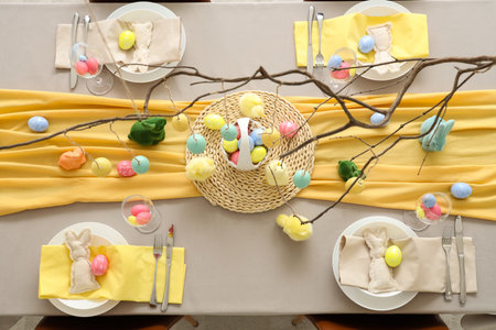 Table setting with Easter eggs, chicks and rabbits, top viewの写真素材