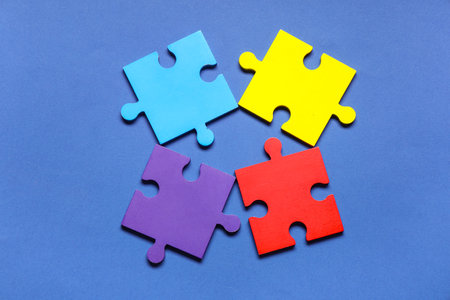 Colorful puzzle pieces on blue background. Autistic disorder conceptの写真素材