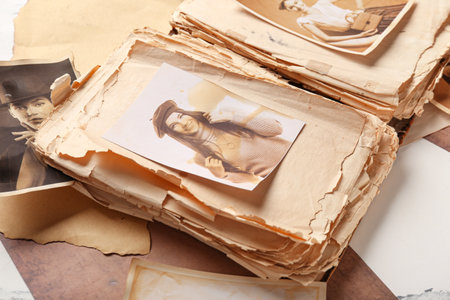 Old album with photos of relatives on white background. Concept of family treeの写真素材