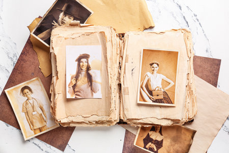 Old album with photos of relatives on white background. Concept of family treeの写真素材