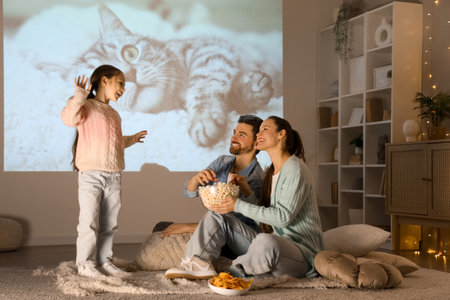 Family having fun during watching of movie at homeの写真素材