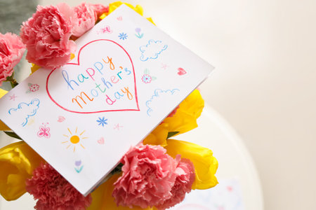 Flowers with card for Mother's Day in room, closeupの写真素材
