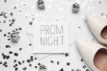 Paper with text PROM NIGHT, envelope, high heels, disco balls and confetti on white backgroundの写真素材