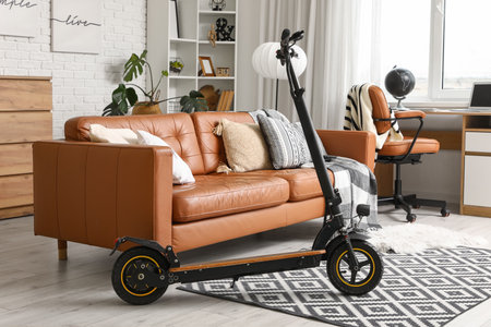 Interior of living room with electric scooter, brown leather sofa and shelving unitの写真素材