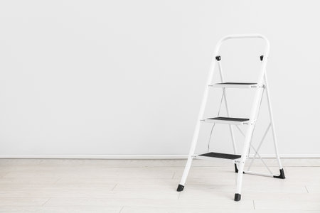 Maintenance ladder near white wallの写真素材