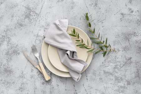 Stylish table setting with eucalyptus branches on gray grunge background. Top viewの写真素材