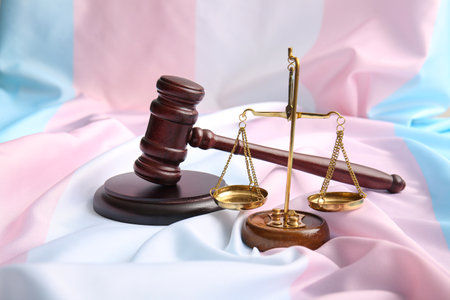 Scales of justice with judge gavel on transgender flagの写真素材