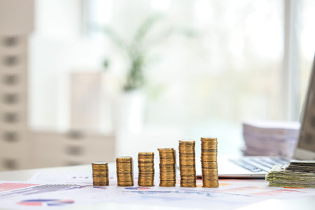 Money and graphs on businessman's workplace