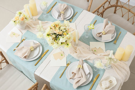 Table setting with beautiful narcissus flowers in room, top view