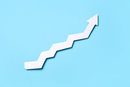 White paper arrow on blue backgroundの写真素材