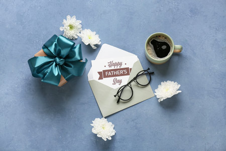 Postcard with gift box, cup of coffee and flowers for Father's Day on blue grunge background