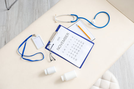 Calendar with doctor's supplies on couch in medical office, top viewの写真素材
