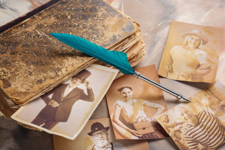 Old album with photos of relatives and pen on grunge background. Concept of family treeの写真素材
