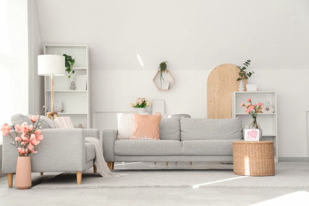 Interior of living room decorated for Mother's Day with sofas and flowersの写真素材