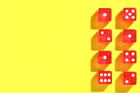 Red game dices on yellow background