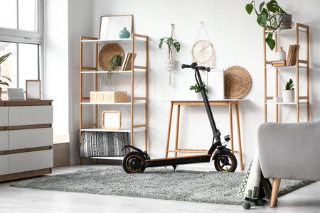 Interior of living room with electric scooter, table and shelf unitsの写真素材