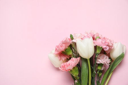 Bouquet of different beautiful flowers on pink background. Mother's Day celebrationの写真素材