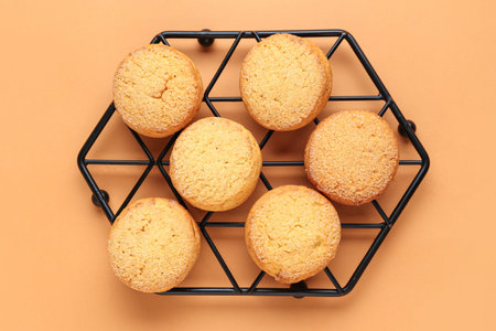 Stand with sweet cookies on brown background