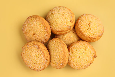 Many sweet cookies on yellow background
