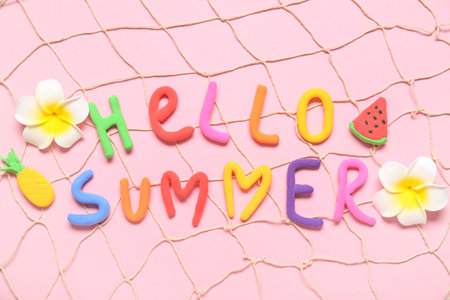 Composition with text HELLO SUMMER, tropical flowers and fish net on pink backgroundの写真素材