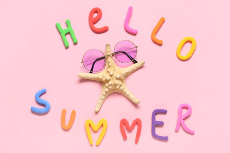 Composition with text HELLO SUMMER, starfish and sunglasses on pink background