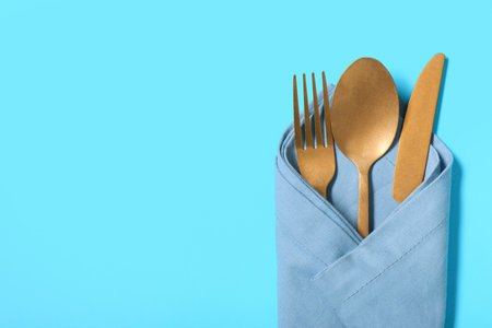 Stylish golden cutlery on blue backgroundの写真素材