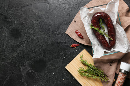 Composition with tasty blood sausage on dark background, top viewの写真素材