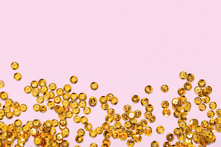 Beautiful golden confetti on lilac background